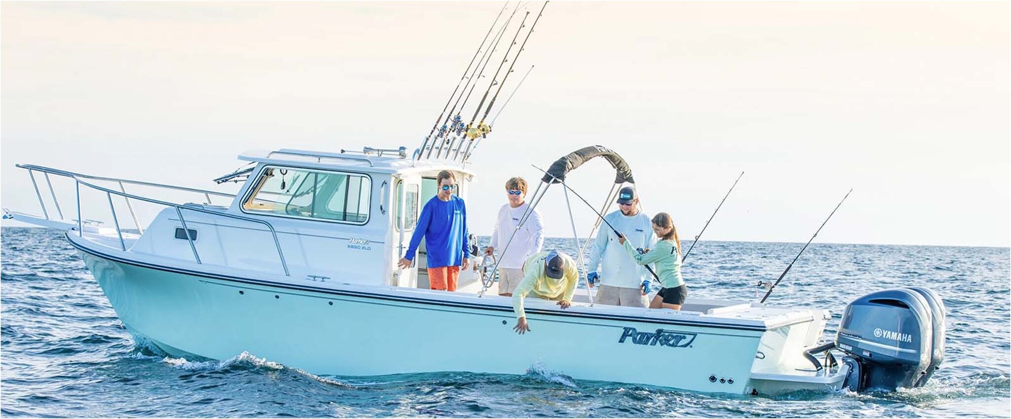 Large boat with people fishing on it in the ocean