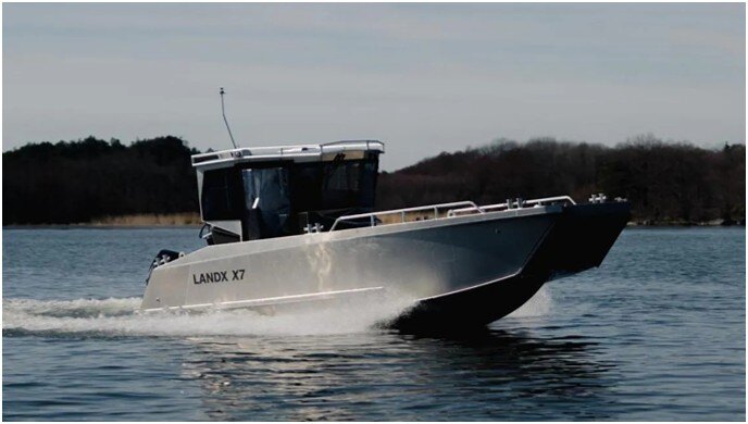 Boat named LANDX in the water