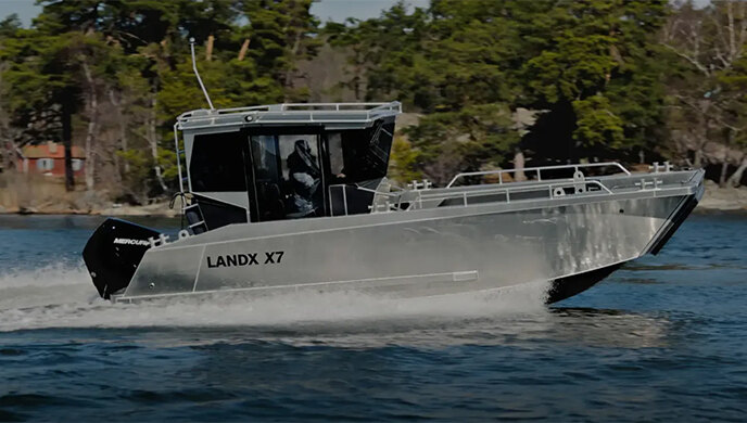 Boat named LANDX in the water